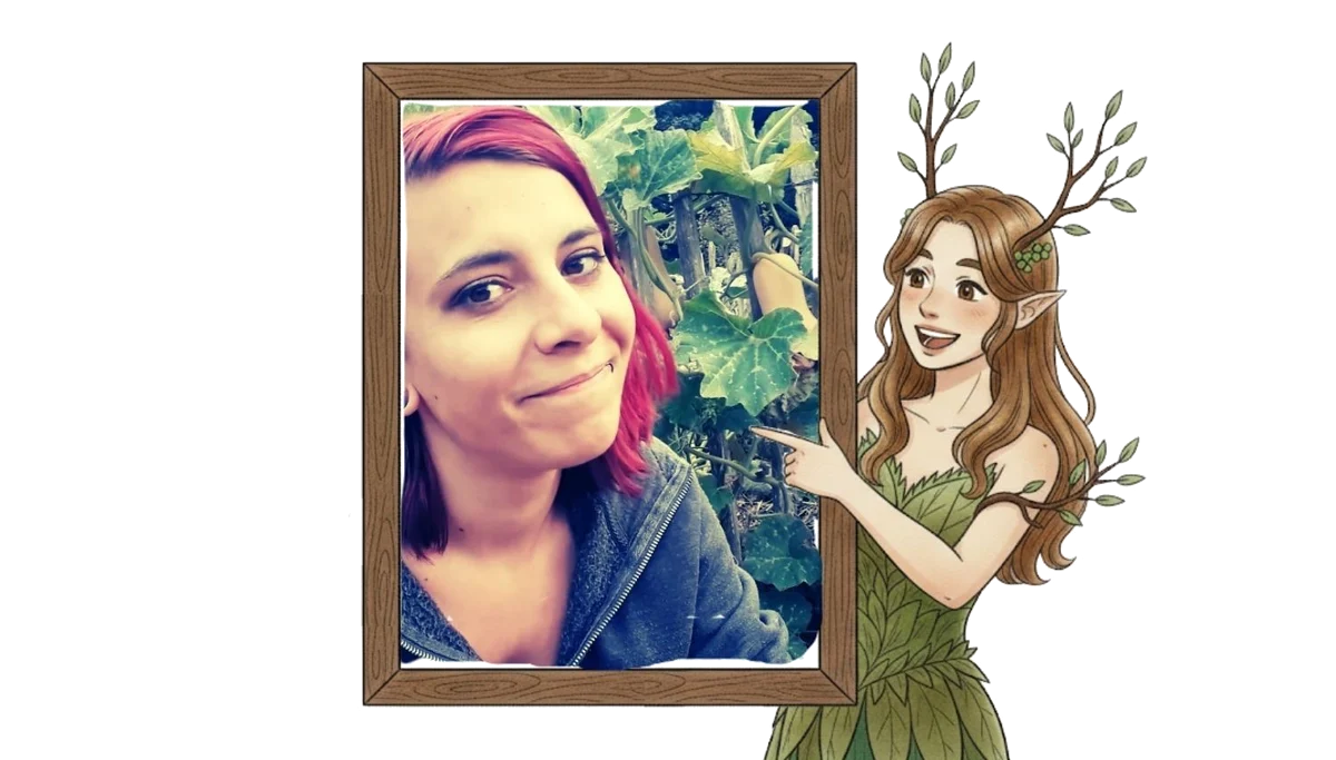 Laure au potager, dans un cadre en bois que la dryade désigne du doigt